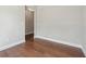 Cozy bedroom space featuring hardwood floors, neutral paint, and a glimpse into the next room at 376 Lakeside Ct, Canton, GA 30114