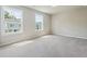 Well-lit bedroom with large windows and neutral-toned walls and carpet at 376 Lakeside Ct, Canton, GA 30114