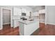 Open kitchen featuring white cabinets, an island with granite countertop, and stainless steel appliances at 376 Lakeside Ct, Canton, GA 30114