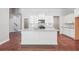 Modern kitchen featuring a large island, granite countertops, stainless steel appliances, and hardwood floors at 376 Lakeside Ct, Canton, GA 30114