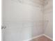 Walk-in closet complete with white storage shelves and neutral carpeting at 376 Lakeside Ct, Canton, GA 30114
