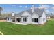 Large backyard featuring covered porch, stone fireplace, and expansive green lawn at 170 Ewing Way, Dacula, GA 30019