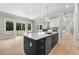 Spacious kitchen with island, granite countertops, and an adjoining fireplace at 170 Ewing Way, Dacula, GA 30019