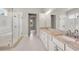 Bright main bathroom with glass enclosed shower, double vanity with granite counters at 170 Ewing Way, Dacula, GA 30019