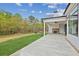 Spacious patio with outdoor fireplace, fan, and views of manicured lawn, and wood line at 170 Ewing Way, Dacula, GA 30019