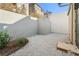 A gravel backyard with a concrete privacy fence and minimal landscaping at 10871 Serenbe Ln, Chattahoochee Hills, GA 30268