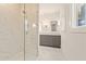 Bathroom featuring a glass walk-in shower with white marble tiles and gray vanity at 10871 Serenbe Ln, Chattahoochee Hills, GA 30268