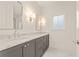 Bathroom featuring a marble countertop, dual sinks and mirrors, and gray vanity at 10871 Serenbe Ln, Chattahoochee Hills, GA 30268