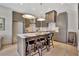 Modern kitchen features stylish gray cabinetry, a marble countertop island with seating at 10871 Serenbe Ln, Chattahoochee Hills, GA 30268