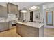 Well-equipped kitchen boasts gray cabinets, stainless steel appliances, and a marble countertop island at 10871 Serenbe Ln, Chattahoochee Hills, GA 30268