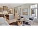 Open living room features a kitchen, a chess table, and light-colored wood flooring at 10871 Serenbe Ln, Chattahoochee Hills, GA 30268