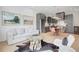 Open living space with a stylish kitchen, dining area, and cozy seating area with modern decor and wood floors at 10871 Serenbe Ln, Chattahoochee Hills, GA 30268