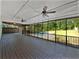 Spacious screened back porch with ceiling fans overlooking a private backyard and swimming pool at 165 Zelkova Dr, Fayetteville, GA 30215