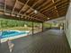 The spacious screened back porch has wood ceiling beams and overlooks the pool in the backyard at 165 Zelkova Dr, Fayetteville, GA 30215