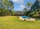 Expansive backyard oasis features a sparkling pool, lush lawn, and mature trees at 165 Zelkova Dr, Fayetteville, GA 30215