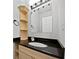 Stylish bathroom featuring a granite countertop, decorative shelving, and modern fixtures at 165 Zelkova Dr, Fayetteville, GA 30215