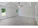 Bright bedroom featuring a tray ceiling, ceiling fan and two large windows at 165 Zelkova Dr, Fayetteville, GA 30215