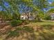 Traditional two-story home with a landscaped front yard and mature trees at 165 Zelkova Dr, Fayetteville, GA 30215
