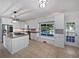 Bright kitchen boasts white cabinetry, stainless appliances, granite counters, and view of the pool at 165 Zelkova Dr, Fayetteville, GA 30215