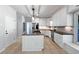 Bright kitchen showcases white cabinetry, stainless steel appliances, and a granite-topped center island at 165 Zelkova Dr, Fayetteville, GA 30215