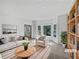 Bright living room features large windows, neutral tones, and stylish staging for an inviting space at 165 Zelkova Dr, Fayetteville, GA 30215