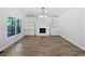 Spacious living room featuring hardwood floors, a fireplace, and built-in bookshelves at 165 Zelkova Dr, Fayetteville, GA 30215