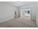 Open-concept living room showcasing neutral paint, crown molding and generous natural light at 165 Zelkova Dr, Fayetteville, GA 30215