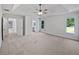 Large main bedroom features new carpet, neutral paint, a ceiling fan, and a view of the backyard at 165 Zelkova Dr, Fayetteville, GA 30215