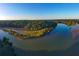 An aerial view reveals a serene river winding through lush green forests under a clear blue sky at 318 Sandy Springs Cir # 110, Atlanta, GA 30328