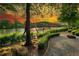 Scenic river view with gravel walking path, lush greenery, and a beautiful sunset sky at 318 Sandy Springs Cir # 110, Atlanta, GA 30328