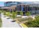 City Springs building exterior featuring a glass facade, brick accents, and landscaped grounds with walking path at 318 Sandy Springs Cir # 160, Atlanta, GA 30328