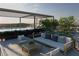 Relaxing rooftop seating area next to the pool with comfortable couches, chairs, and a shade structure at 318 Sandy Springs Cir # 160, Atlanta, GA 30328