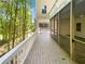 Spacious back porch with screened-in section and beautiful views of wooded backyard at 819 Bermuda Run, Woodstock, GA 30189