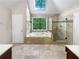 Luxurious bathroom with soaking tub, skylight, tiled shower, and double vanity at 819 Bermuda Run, Woodstock, GA 30189