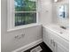 This bathroom features a vanity sink, modern fixtures, and a large window for natural light at 819 Bermuda Run, Woodstock, GA 30189