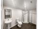Bathroom featuring a pedestal sink, toilet, and glass-enclosed shower at 819 Bermuda Run, Woodstock, GA 30189