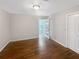 Neutral bedroom featuring hardwood floors, light walls, and a door leading to an outdoor view at 819 Bermuda Run, Woodstock, GA 30189