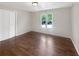 This bedroom features hardwood floors, double closets, and natural lighting at 819 Bermuda Run, Woodstock, GA 30189
