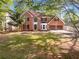 Charming two-story brick home with manicured lawn and attached two-car garage at 819 Bermuda Run, Woodstock, GA 30189