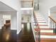 Entryway featuring stairs with rod iron spindles and dark wood floors at 819 Bermuda Run, Woodstock, GA 30189