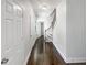 This bright hallway leads to the bedrooms and features hardwood floors and a staircase at 819 Bermuda Run, Woodstock, GA 30189