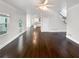 Large living room with hardwood floors, connecting to kitchen and staircase at 819 Bermuda Run, Woodstock, GA 30189