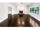 Living room features a fireplace, built-in bookshelves and hardwood floors at 819 Bermuda Run, Woodstock, GA 30189