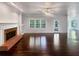 Living room with fireplace and built-in shelves, hardwood floors, and natural light at 819 Bermuda Run, Woodstock, GA 30189