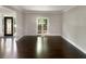 A living room space with hardwood floors, neutral walls, and a window with natural light at 819 Bermuda Run, Woodstock, GA 30189