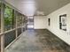 This screened porch offers views of a wooded backyard and has neutral colors at 819 Bermuda Run, Woodstock, GA 30189
