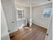 Bright bathroom with white vanity, mirror, and tiled shower, plus hardwood floors at 125 Enterprise Dr, Temple, GA 30179