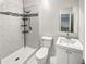 Modern bathroom with white tiled shower, mosaic accents, toilet, and single sink vanity with mirror at 125 Enterprise Dr, Temple, GA 30179