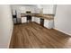 Eat-in kitchen with stainless steel appliances, wood look flooring, and white cabinets at 125 Enterprise Dr, Temple, GA 30179