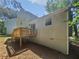 Home backyard featuring a wood deck, siding, and view of the surrounding trees at 5723 Antelope Trl, Atlanta, GA 30349